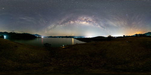 Scenic view of lake against sky at night