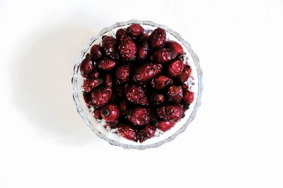 High angle view of strawberries on table against white background