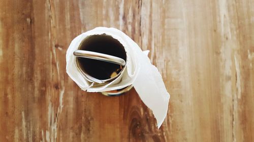 High angle view of toilet paper on wooden table