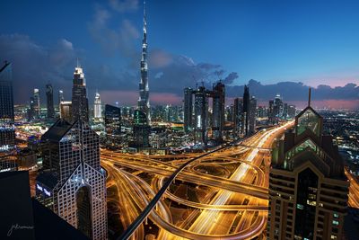 High angle view of city lit up at night