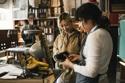 Customer paying through credit card at repair shop