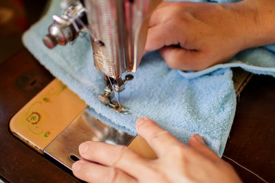 High angle view of person working on sewing machine