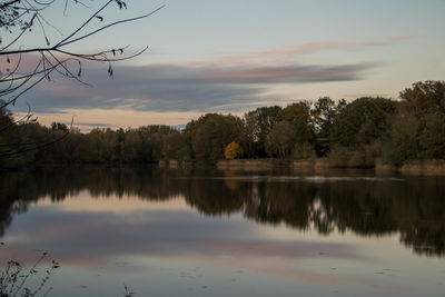 Scenic view of lake against sky at sunset