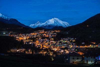 Aerial view of illuminated city against sky at night