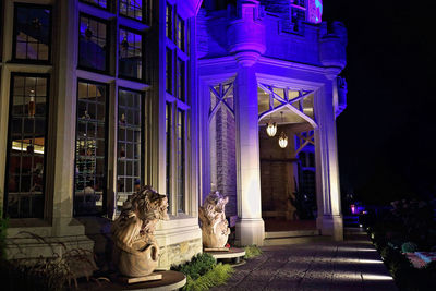 Woman sitting in illuminated building at night