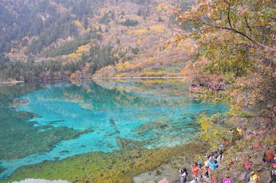 High angle view of people by lake at jiuzhaigou