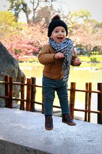 Portrait of cute boy standing outdoors