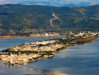 High angle view of city by sea against sky