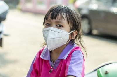 Close-up of girl wearing surgical mask