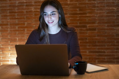 Young woman using laptop at office