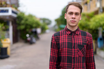 Portrait of young man standing outdoors