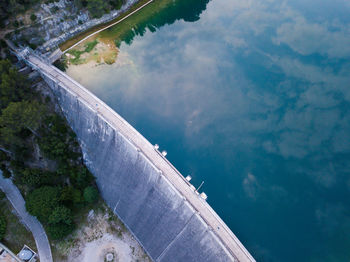 High angle view of dam amidst trees against sky