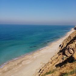 Scenic view of beach against blue sky