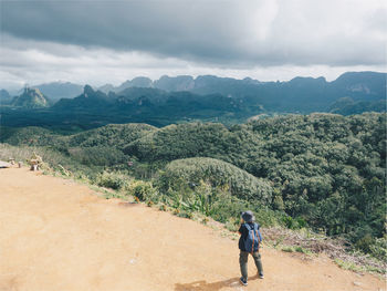 Rear view of man on landscape against sky