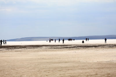 People on land against sky