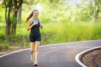 Young woman exercising on road