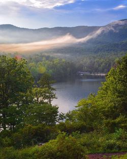 High angle view of calm countryside lake against mountain range