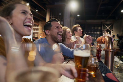 Portrait of friends sitting at restaurant