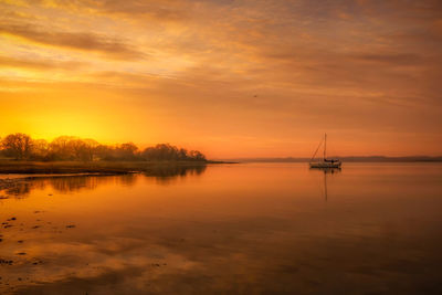 Scenic view of sea against orange sky