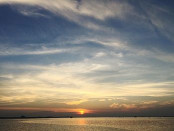 View of sea against cloudy sky during sunset