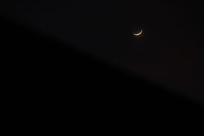 Low angle view of moon against sky at night