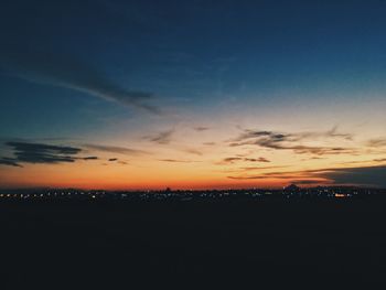 Silhouette cityscape against sky during sunset