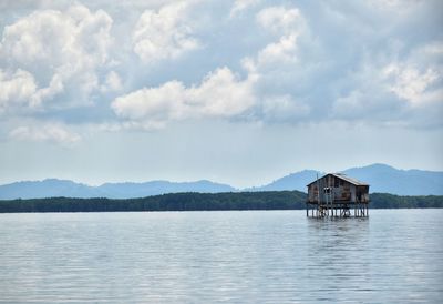Scenic view of lake by building against sky