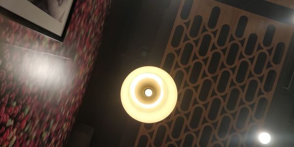 Low angle view of illuminated lamp on ceiling