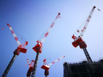 Low angle view of crane against sky