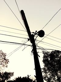 Low angle view of power lines against sky