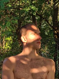 Portrait of shirtless man looking away