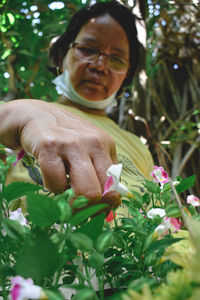 Man holding flowering plant