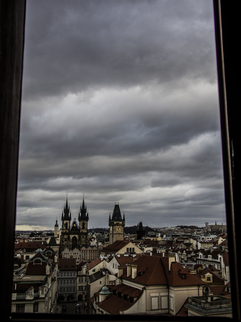 HIGH ANGLE VIEW OF CITY BUILDINGS AGAINST CLOUDY SKY