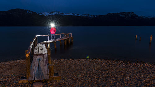 Scenic view of lake against sky at night