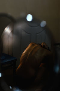 Rear view of shirtless man at home
