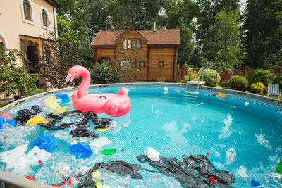 High angle view of swimming pool against trees and house