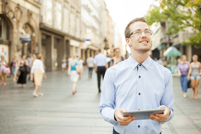 Portrait of young man standing on street