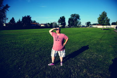 Girl standing on grassy field