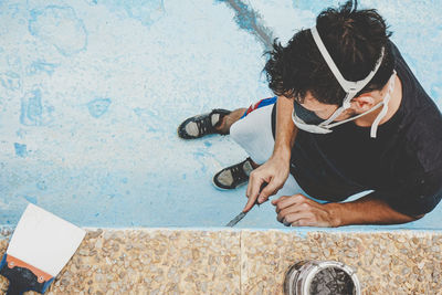 High angle view of young woman sitting in swimming pool