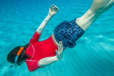 High angle view of woman swimming in sea