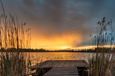 Scenic view of lake against orange sky