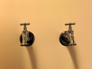 Close-up of faucets on wall