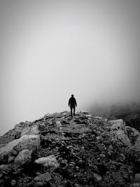 Silhouette man on mountain against clear sky