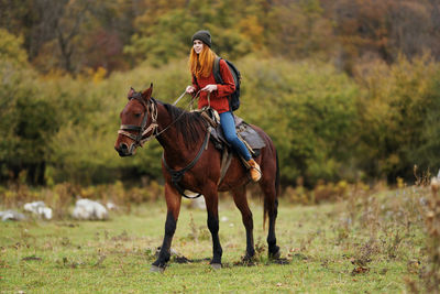 Man riding horse on field