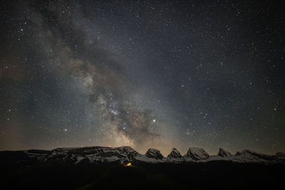 Scenic view of mountains against star field