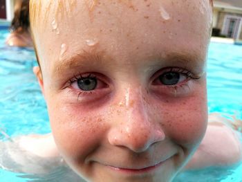 Close-up portrait of boy in swimming pool