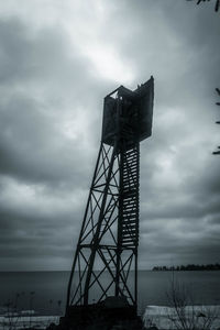 Low angle view of communications tower against sky