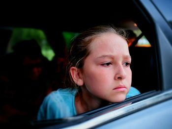 Close-up of serious girl in car