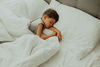 Young woman sleeping on bed at home