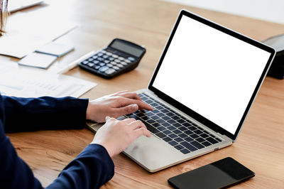 High angle view of woman using laptop on table